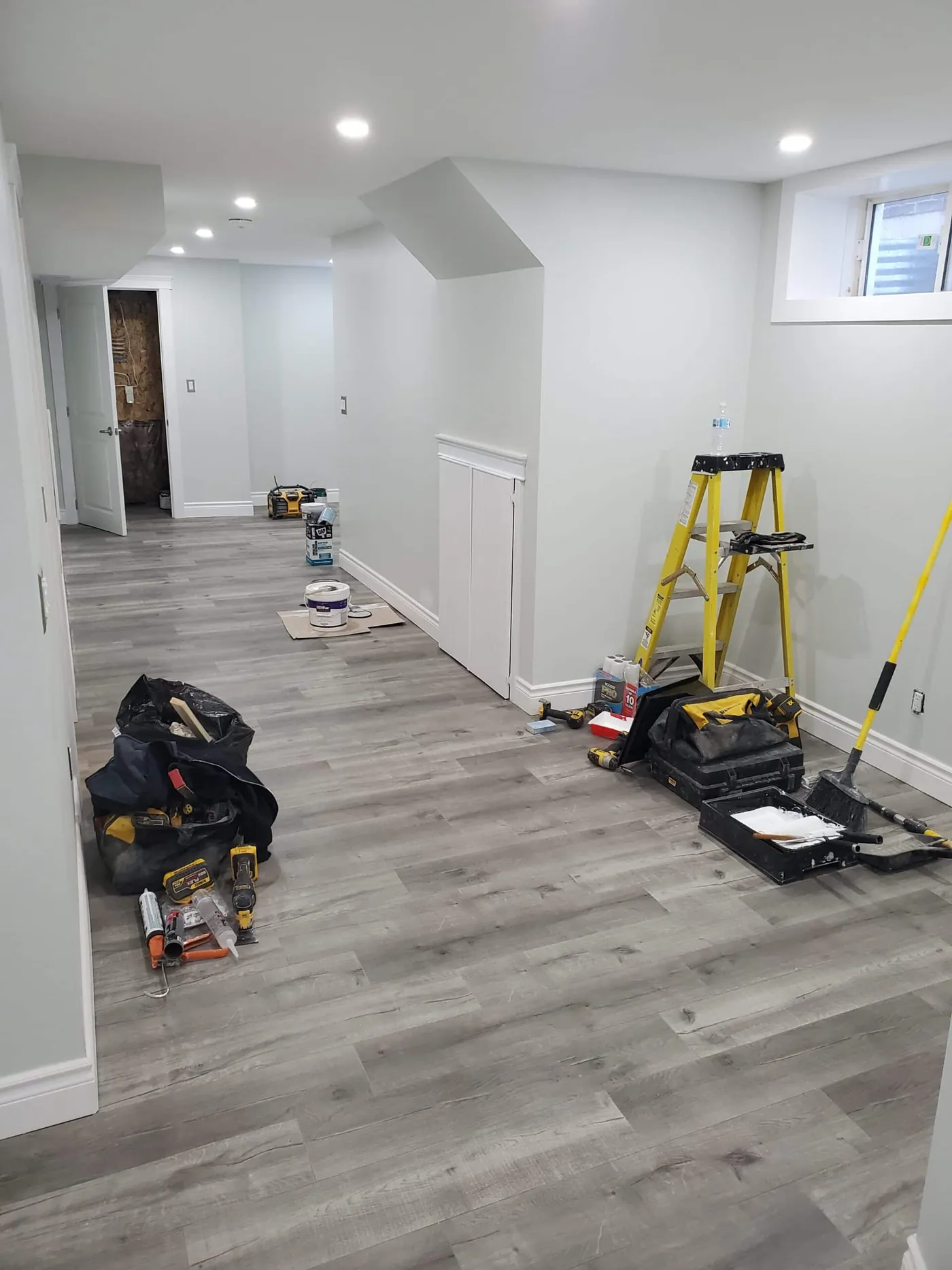 Family room during painting with surfaces protected and trim in progress