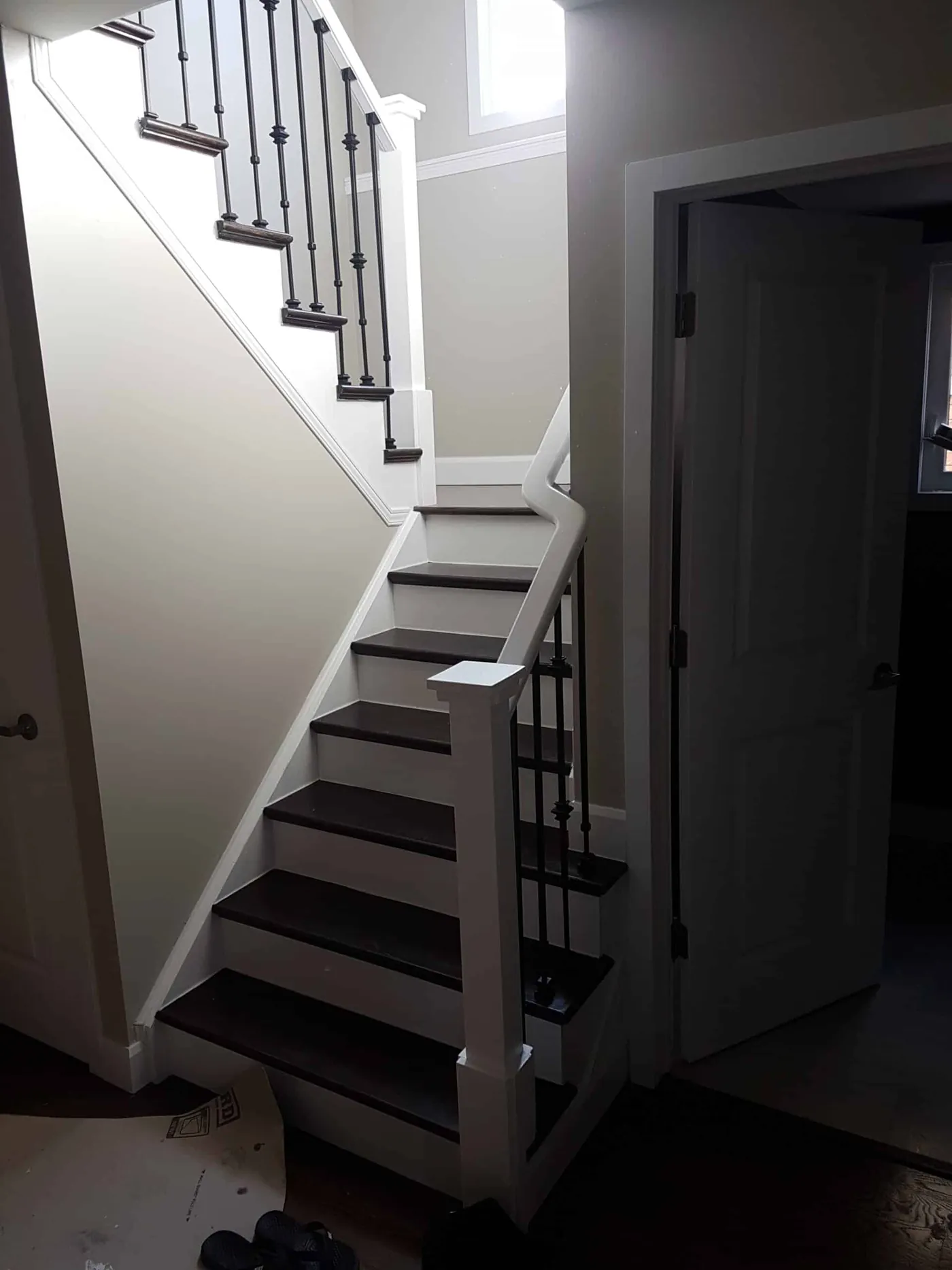 Staircase with white risers, dark treads and iron spindles